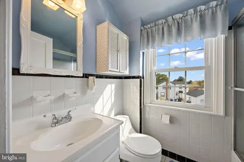 a bathroom with a sink toilet and mirror