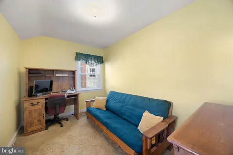 a living room with furniture and a flat screen tv with wooden floor