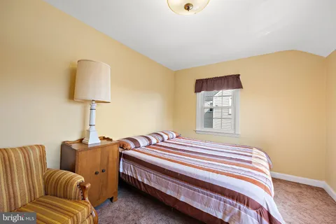 a bedroom with a bed and a lamp on table