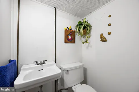 a white toilet sitting next to a white sink