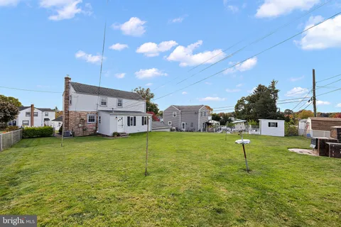 a house view with a play ground in front of it