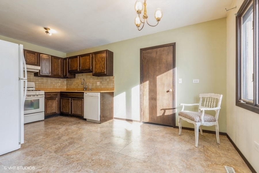 628 West Main Street Cary, IL 60013 - Photo 8 of 20 a kitchen with a cabinets and chairs