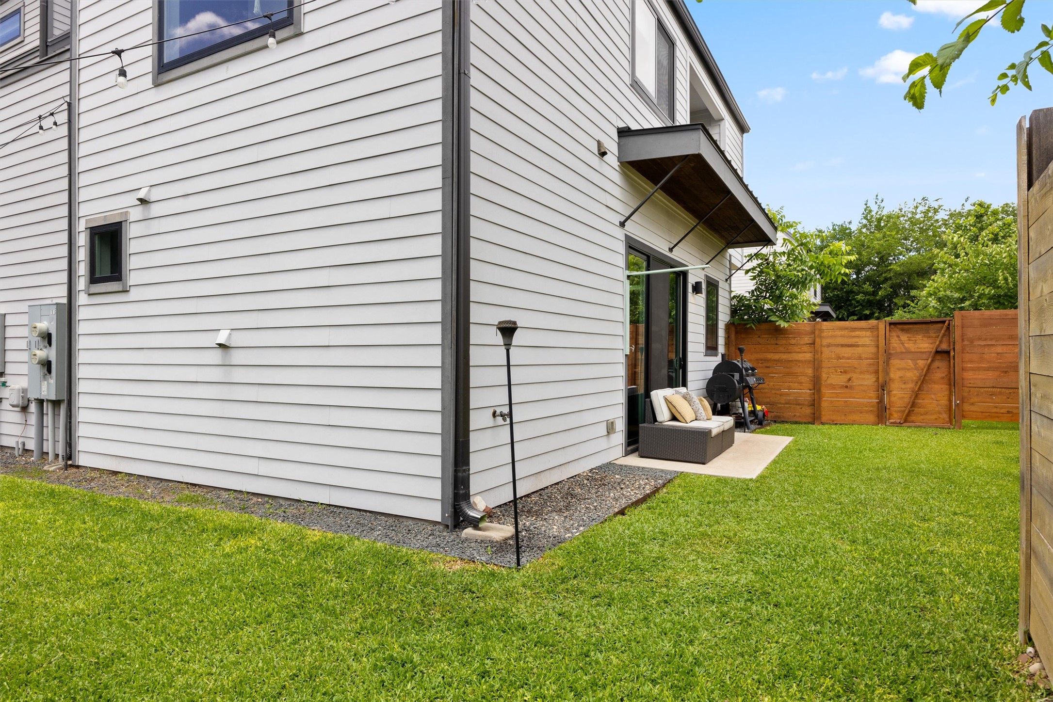 1116 Stobaugh Street, Unit B Austin, TX 78757 - Photo 33 of 38 Wood fencing adds privacy while complementing the home’s modern aesthetic.