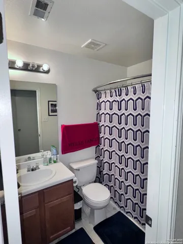 a living room with a table and paintings on the wall