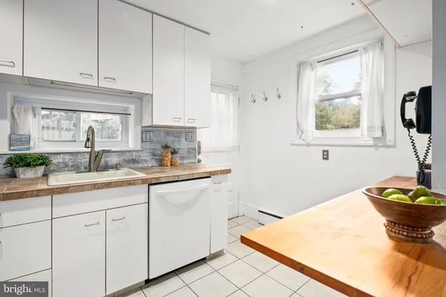 a kitchen with stainless steel appliances a stove a sink a microwave and cabinets