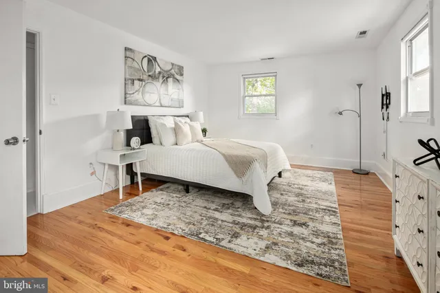 a spacious bedroom with a bed and a window