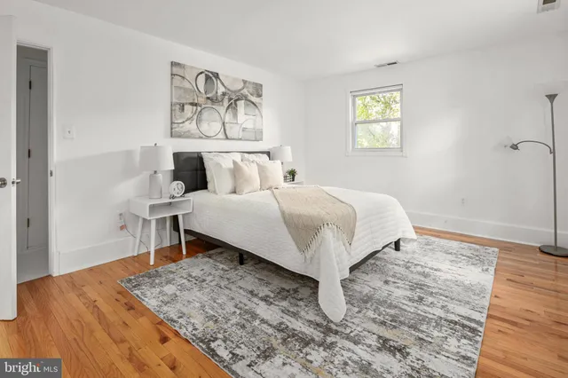 a bedroom with a large bed and a window