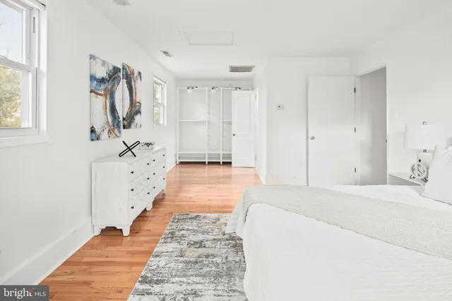 a bathroom with a double vanity sink a mirror and a bathtub