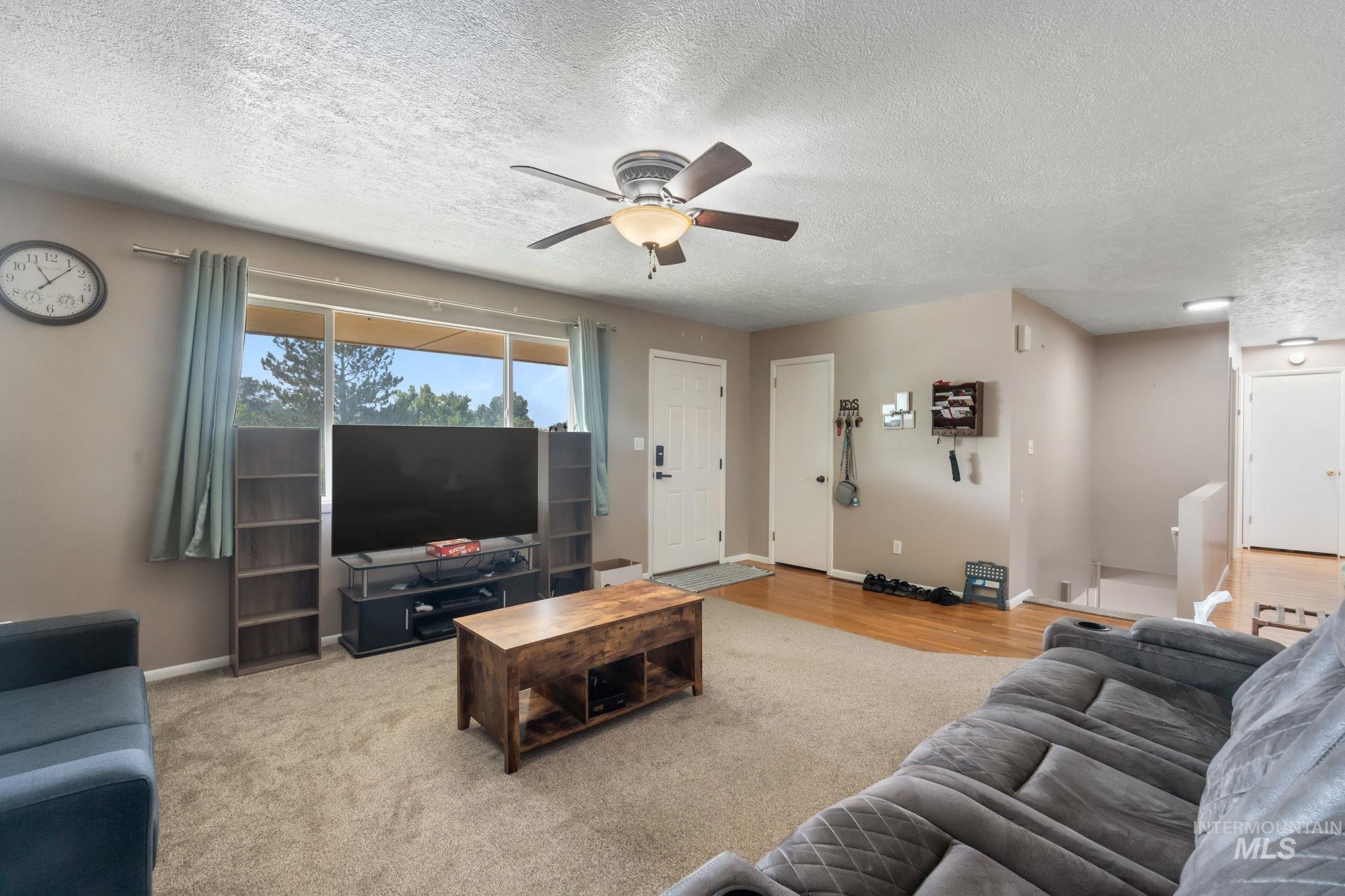 816 Park Lane Pocatello, ID 83201 - Photo 8 of 48 Living area with ceiling fan, a textured ceiling, and wood finished floors