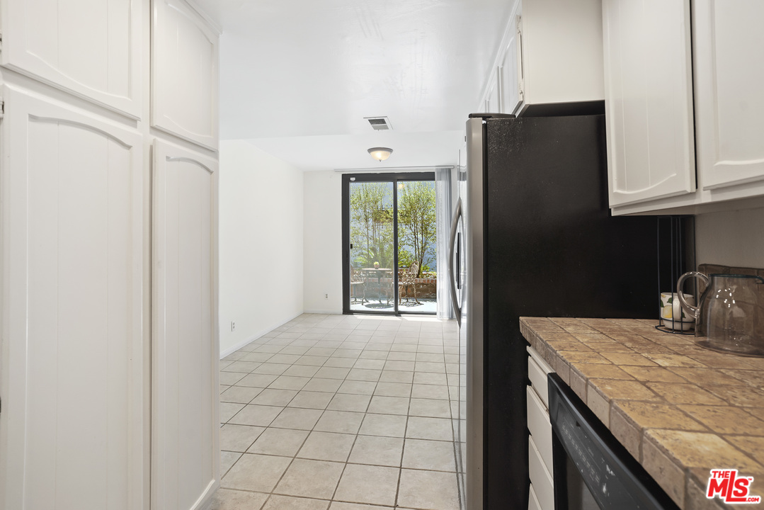 8135 Redlands Street, Unit 101 Playa del Rey, CA 90293 - Photo 13 of 42 a kitchen with windows and refrigerator