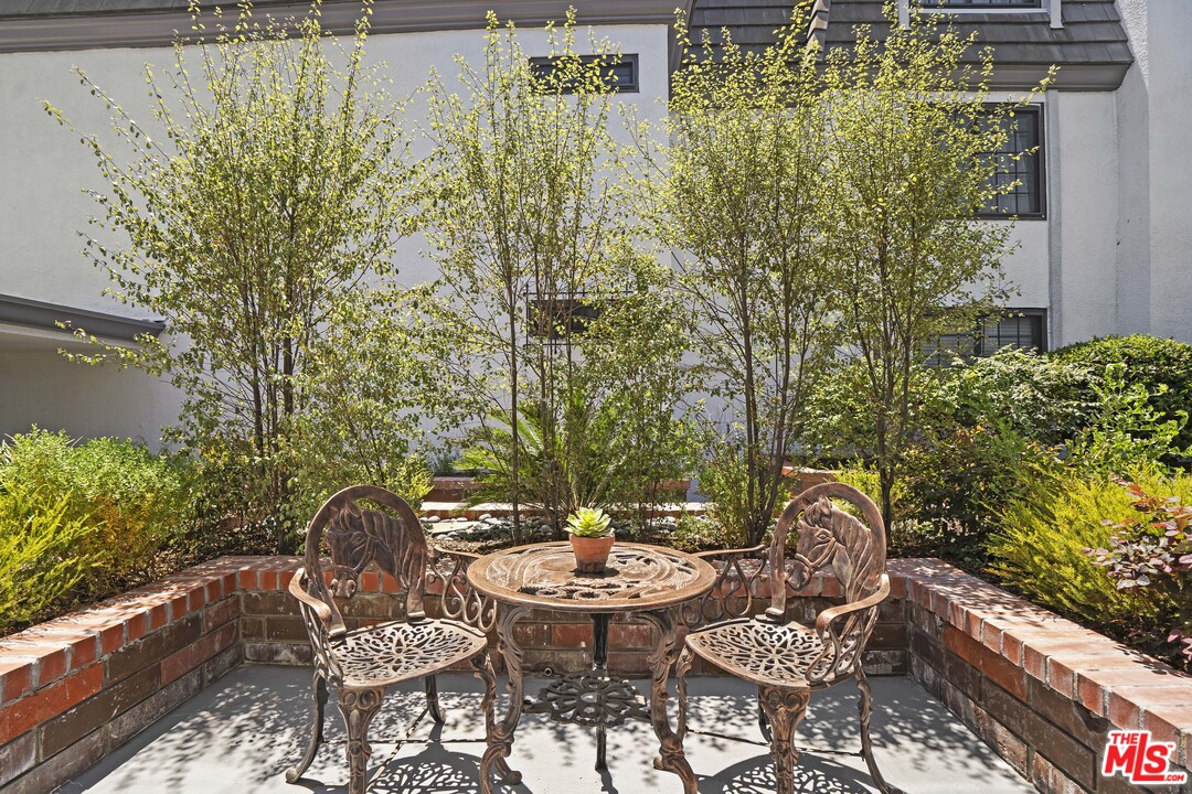 8135 Redlands Street, Unit 101 Playa del Rey, CA 90293 - Photo 16 of 42 a backyard of a house with table and chairs plants