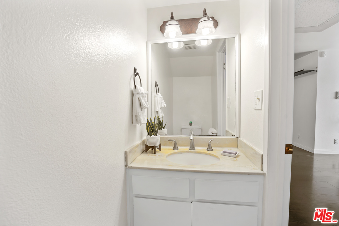 8135 Redlands Street, Unit 101 Playa del Rey, CA 90293 - Photo 22 of 42 a bathroom with a granite countertop sink and a mirror