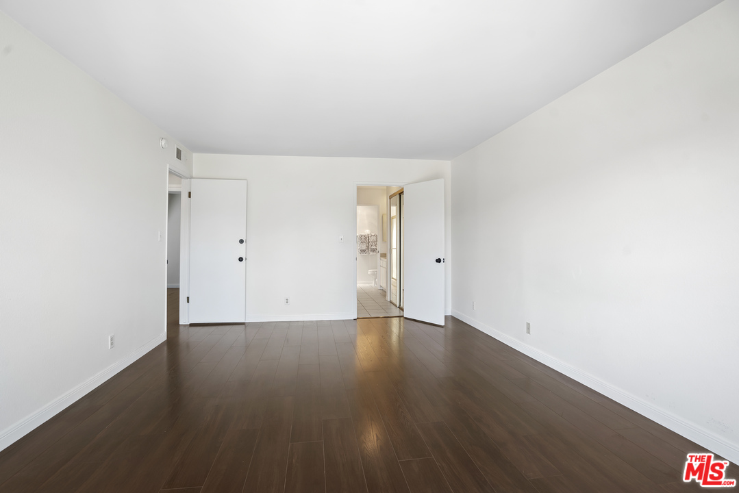 8135 Redlands Street, Unit 101 Playa del Rey, CA 90293 - Photo 25 of 42 an empty room with wooden floor and windows