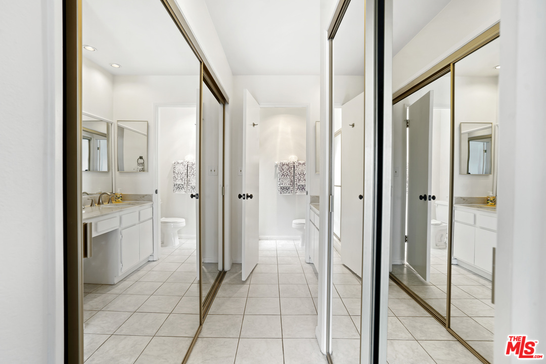 8135 Redlands Street, Unit 101 Playa del Rey, CA 90293 - Photo 26 of 42 a bathroom with a granite countertop shower mirror and a sink
