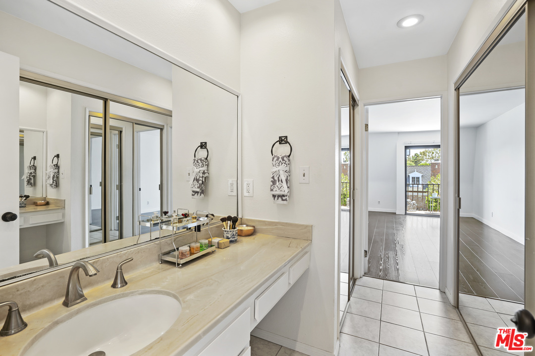 8135 Redlands Street, Unit 101 Playa del Rey, CA 90293 - Photo 29 of 42 a bathroom with a granite countertop sink mirror and double
