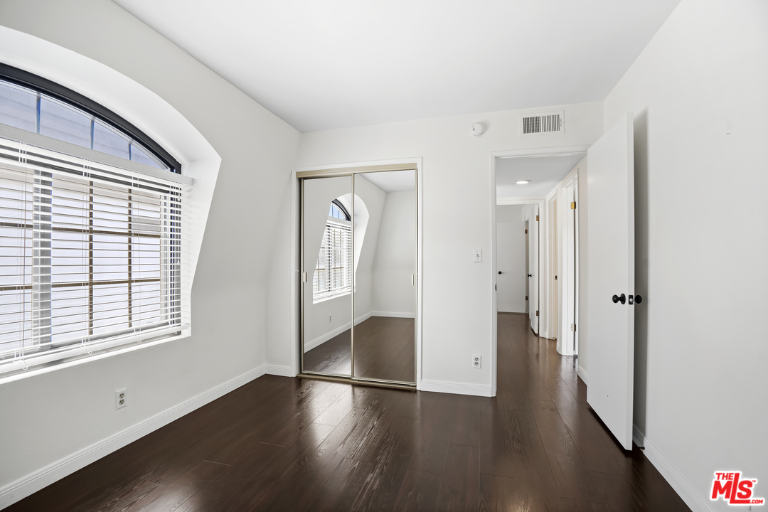 8135 Redlands Street, Unit 101 Playa del Rey, CA 90293 - Photo 34 of 42 an empty room with wooden floor and windows