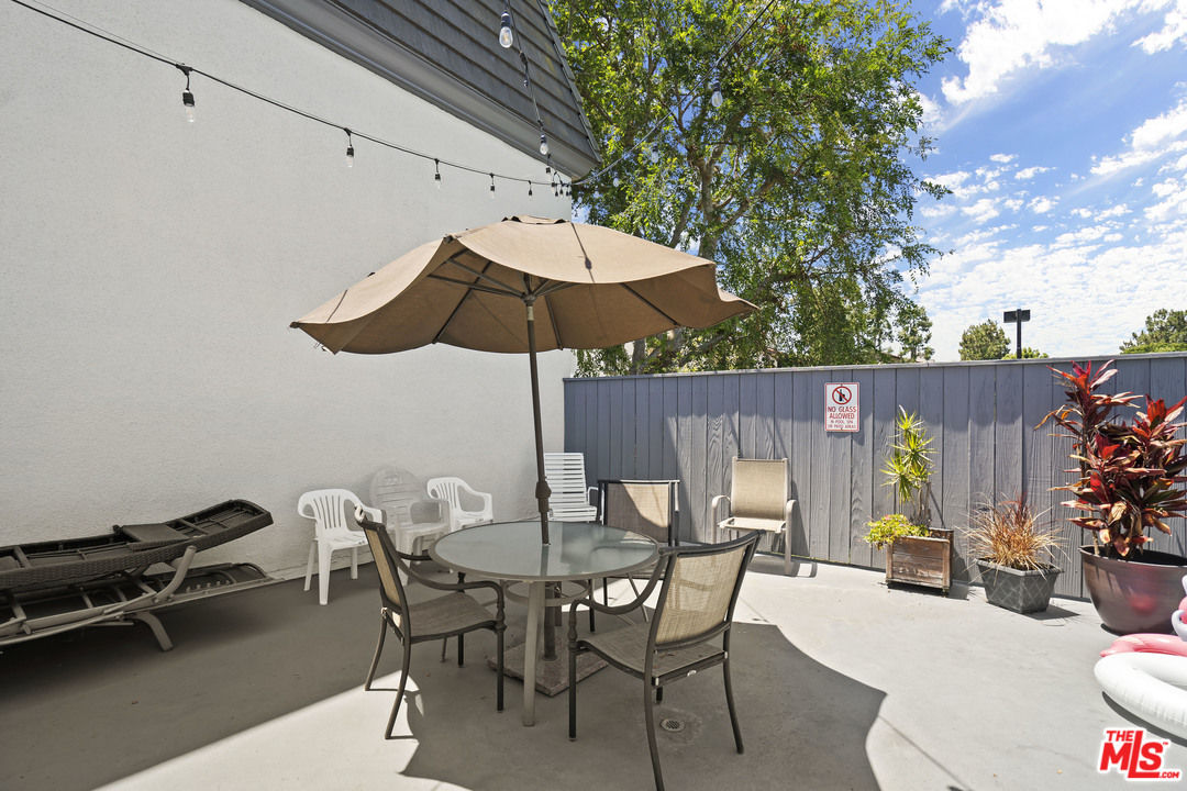 8135 Redlands Street, Unit 101 Playa del Rey, CA 90293 - Photo 38 of 42 a view of a dinning table and chairs in the patio