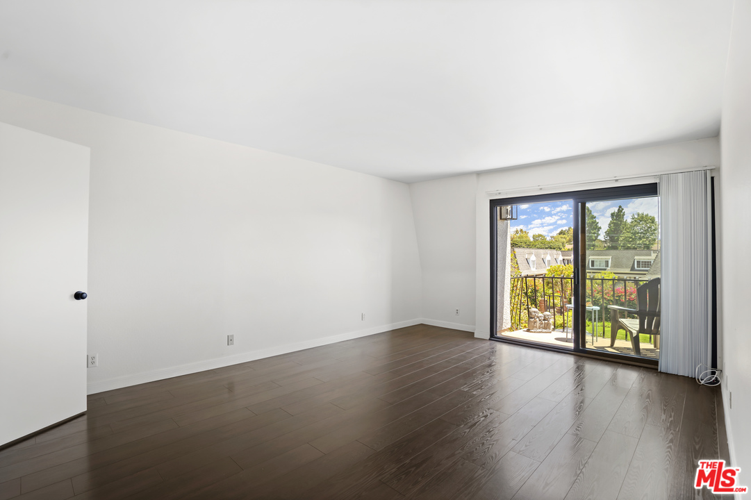 8135 Redlands Street, Unit 101 Playa del Rey, CA 90293 - Photo 6 of 42 an empty room with wooden floor and windows