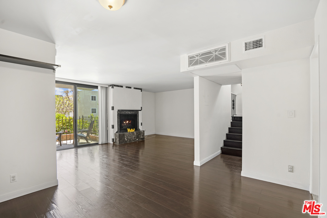8135 Redlands Street, Unit 101 Playa del Rey, CA 90293 - Photo 7 of 42 a view of a livingroom with wooden floor and a fireplace