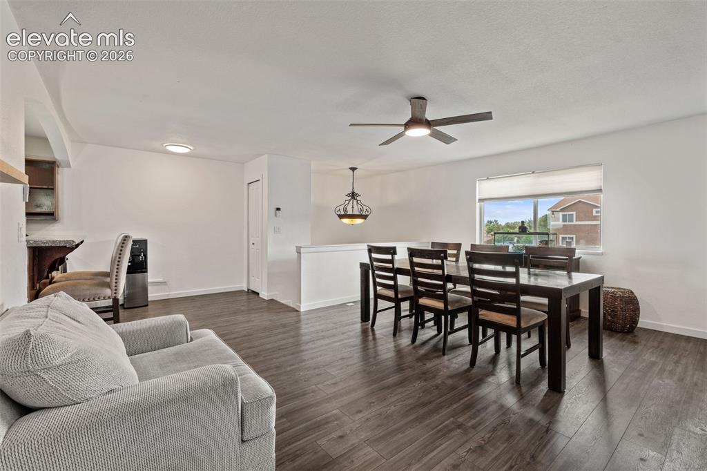 125 Diamond E Road Fountain, CO 80817 - Photo 12 of 43 a living room with furniture a dining table and wooden floor