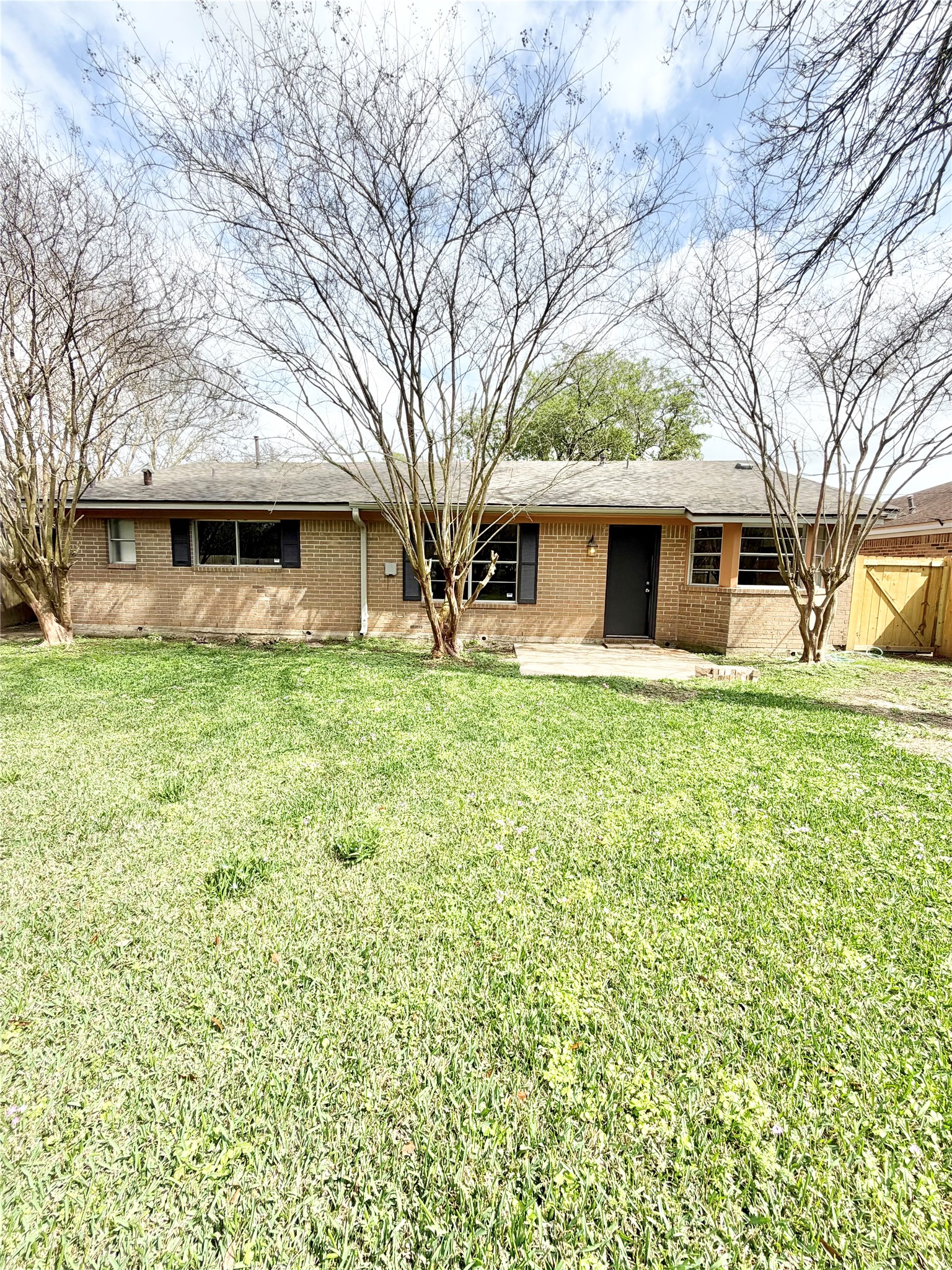 98 Sparrow Way Beaumont, TX 77707 - Photo 21 of 25 a front view of a house with a garden and trees