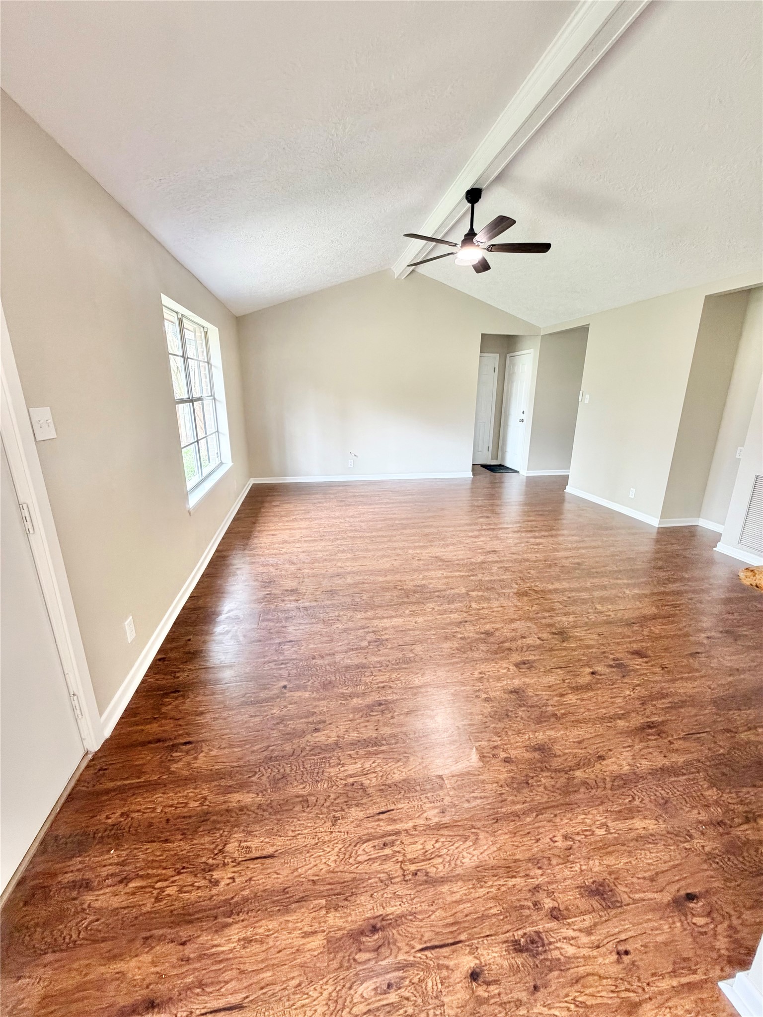 98 Sparrow Way Beaumont, TX 77707 - Photo 3 of 25 wooden floor in an empty room with a window