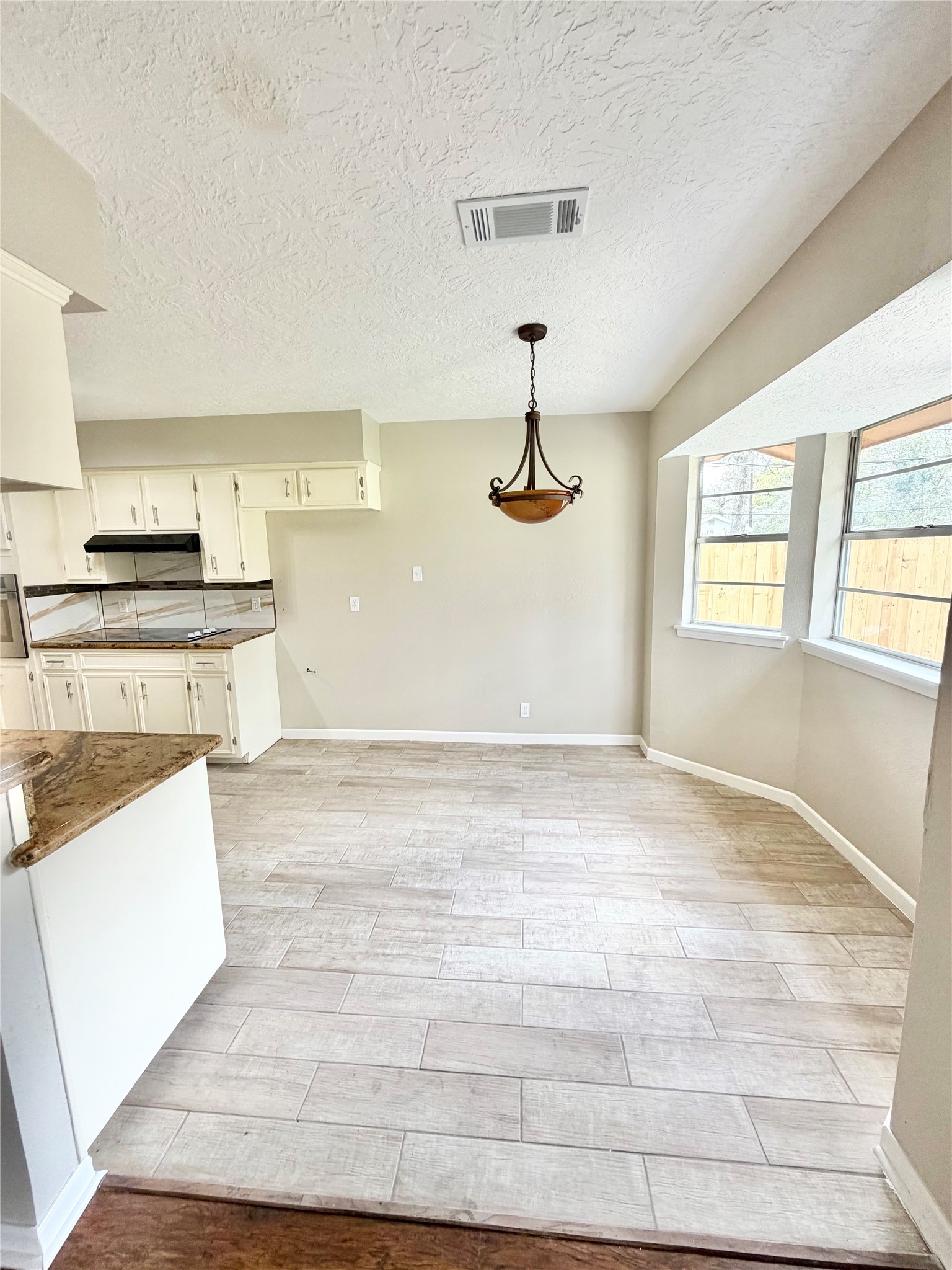 98 Sparrow Way Beaumont, TX 77707 - Photo 5 of 25 a view of a kitchen with a stove wooden floor and a kitchen space