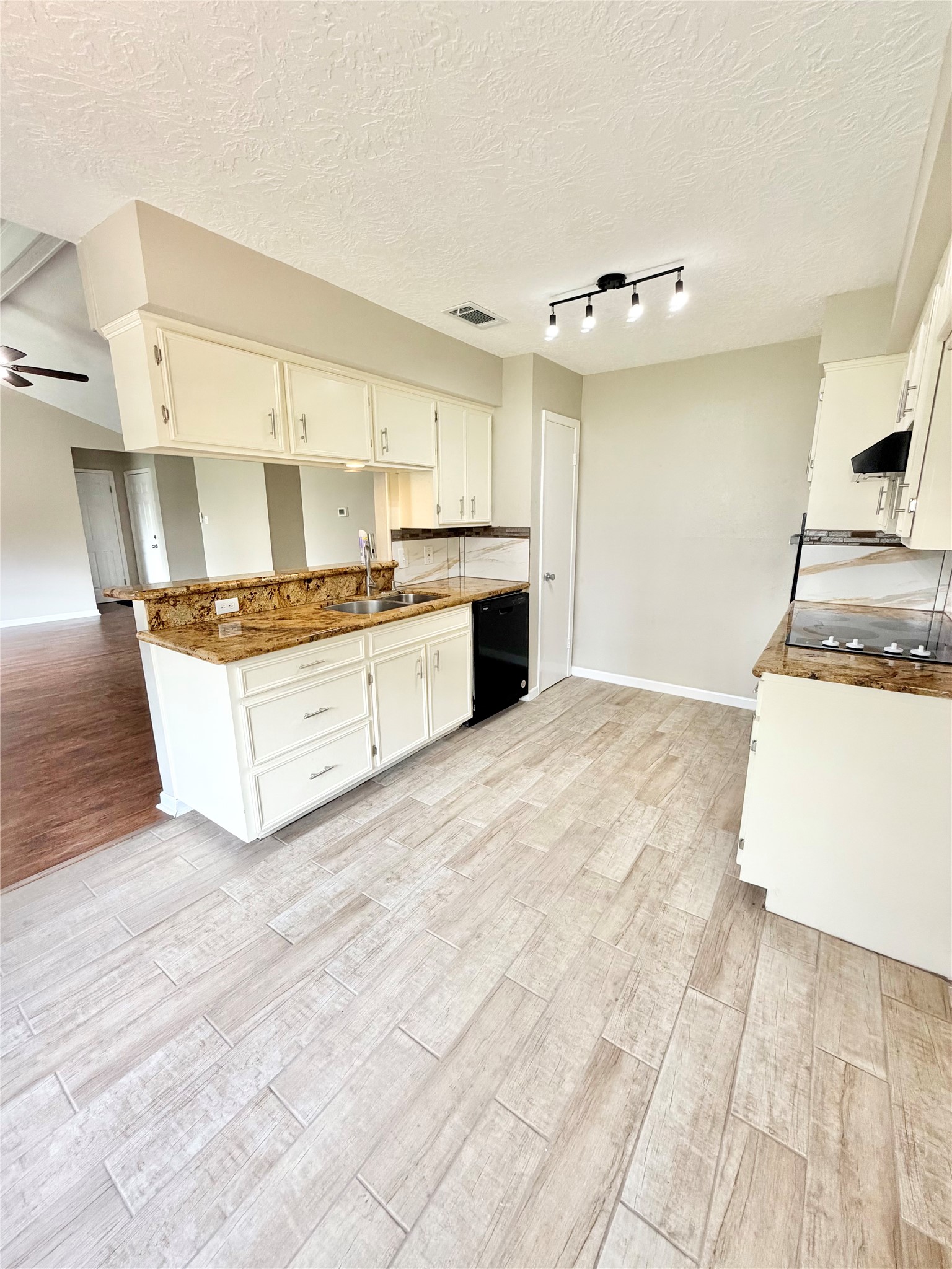 98 Sparrow Way Beaumont, TX 77707 - Photo 6 of 25 a large white kitchen with stainless steel appliances granite countertop a stove and a sink