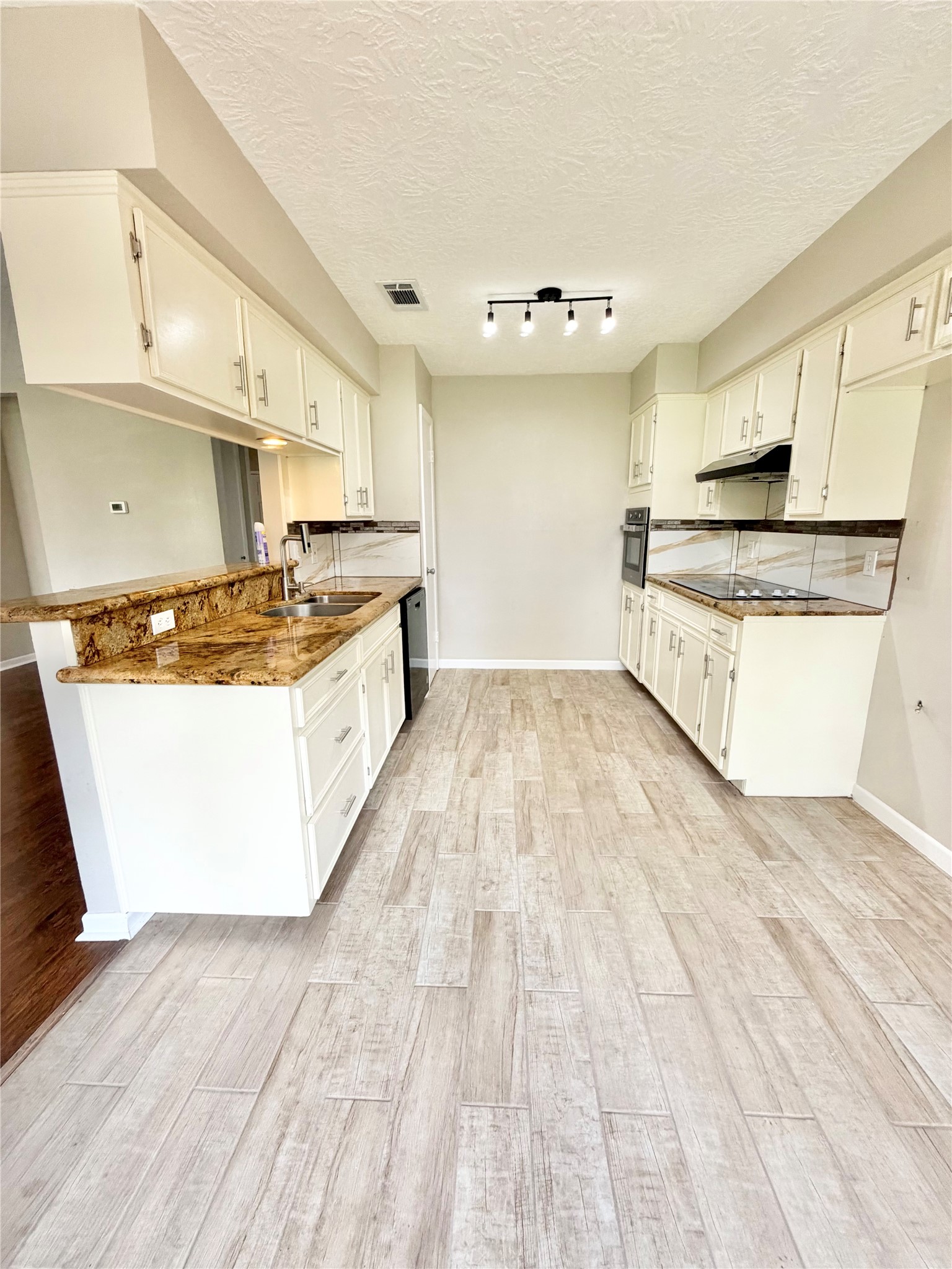98 Sparrow Way Beaumont, TX 77707 - Photo 7 of 25 a kitchen with stainless steel appliances granite countertop a stove a sink and a microwave