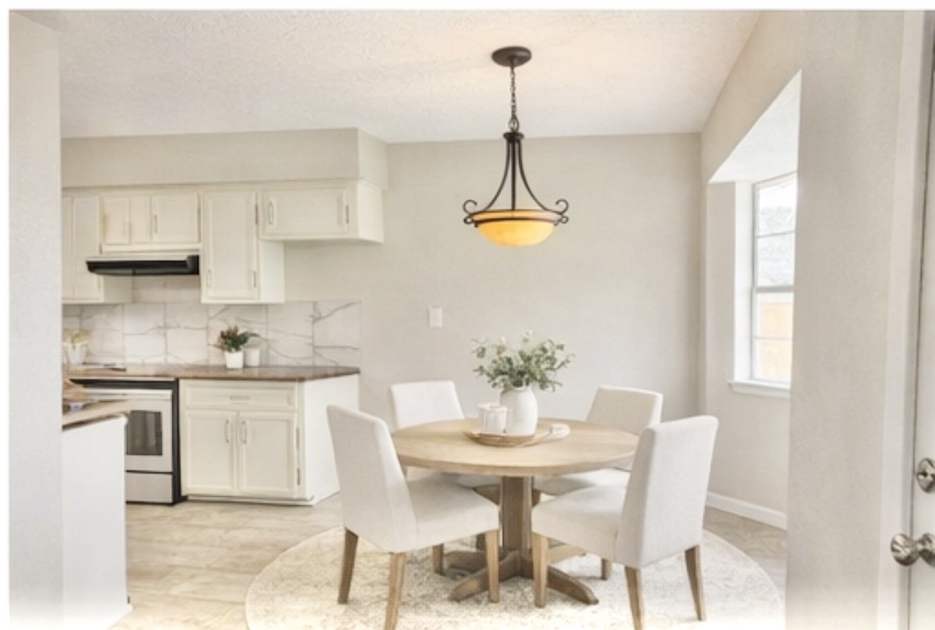 98 Sparrow Way Beaumont, TX 77707 - Photo 10 of 25 a kitchen with stainless steel appliances a dining table chairs and white cabinets