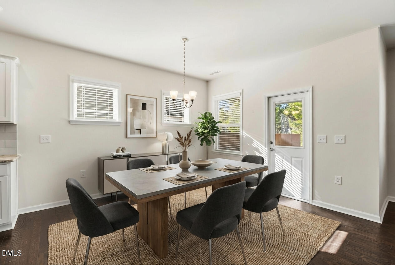 1018 Flyfish Avenue Durham, NC 27703 - Photo 18 of 54 a view of a dining room with furniture and wooden floor