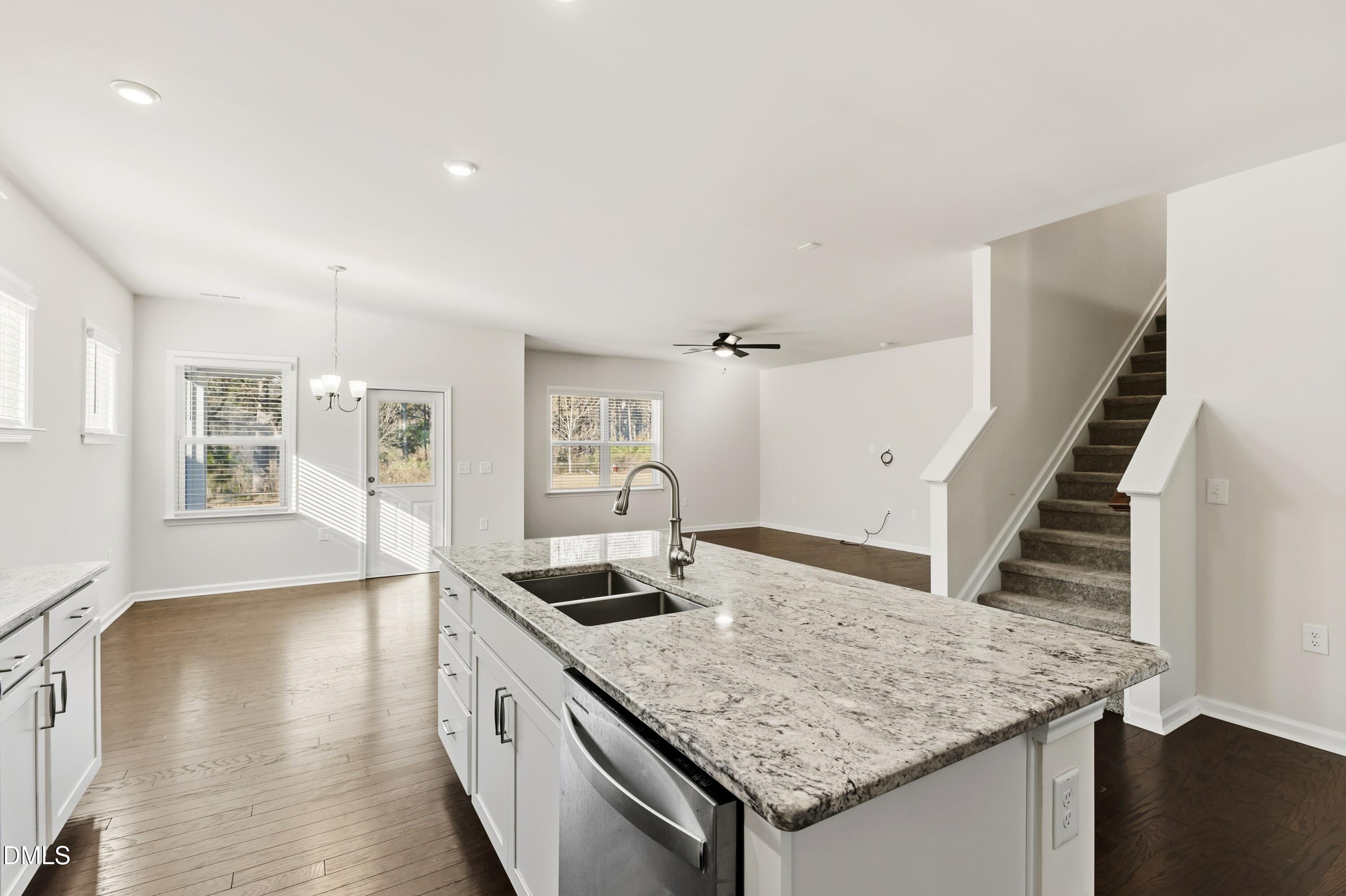 1018 Flyfish Avenue Durham, NC 27703 - Photo 22 of 54 a kitchen with a stove a sink and a wooden floor