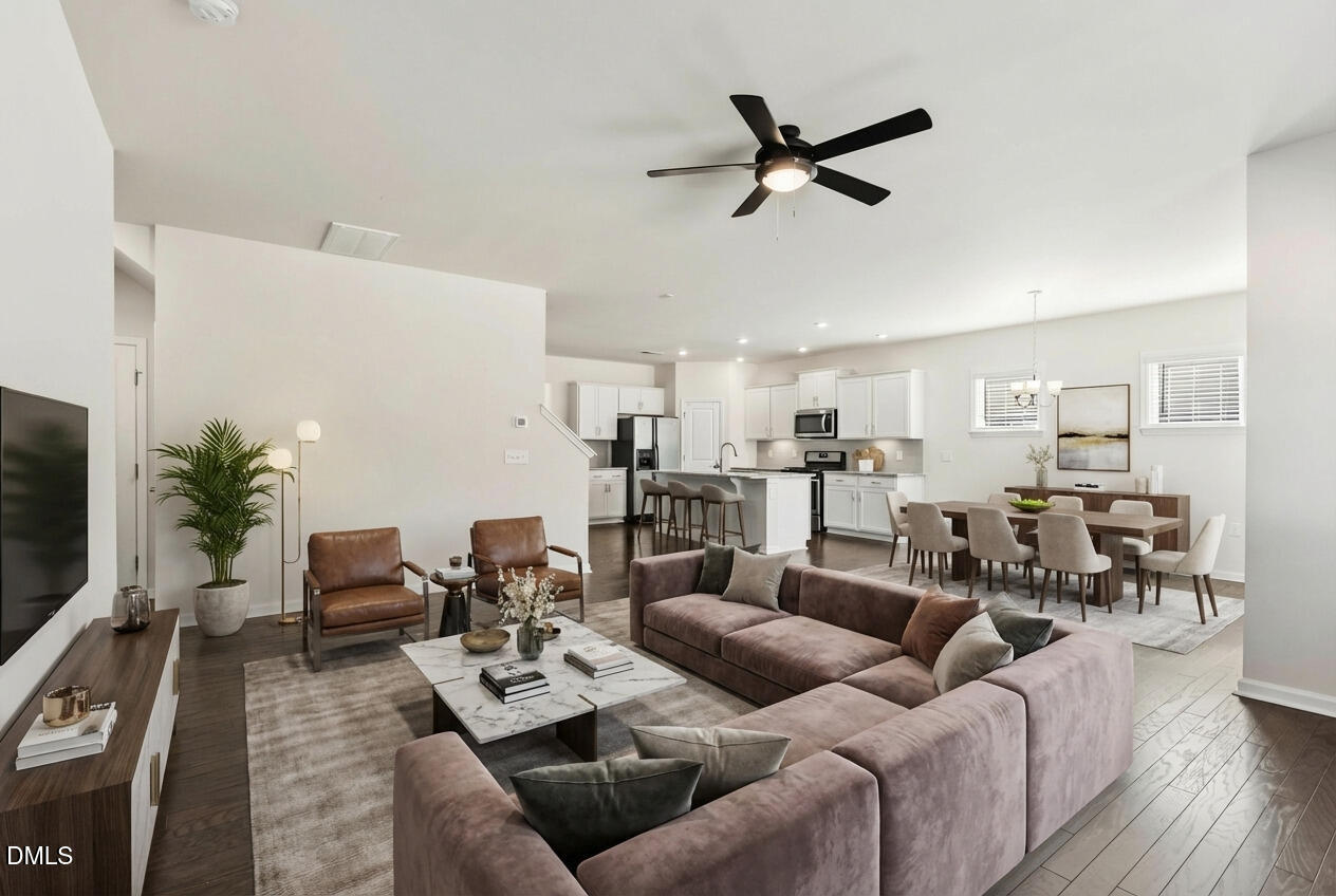 1018 Flyfish Avenue Durham, NC 27703 - Photo 24 of 54 a living room with furniture floor to ceiling window and a flat screen tv