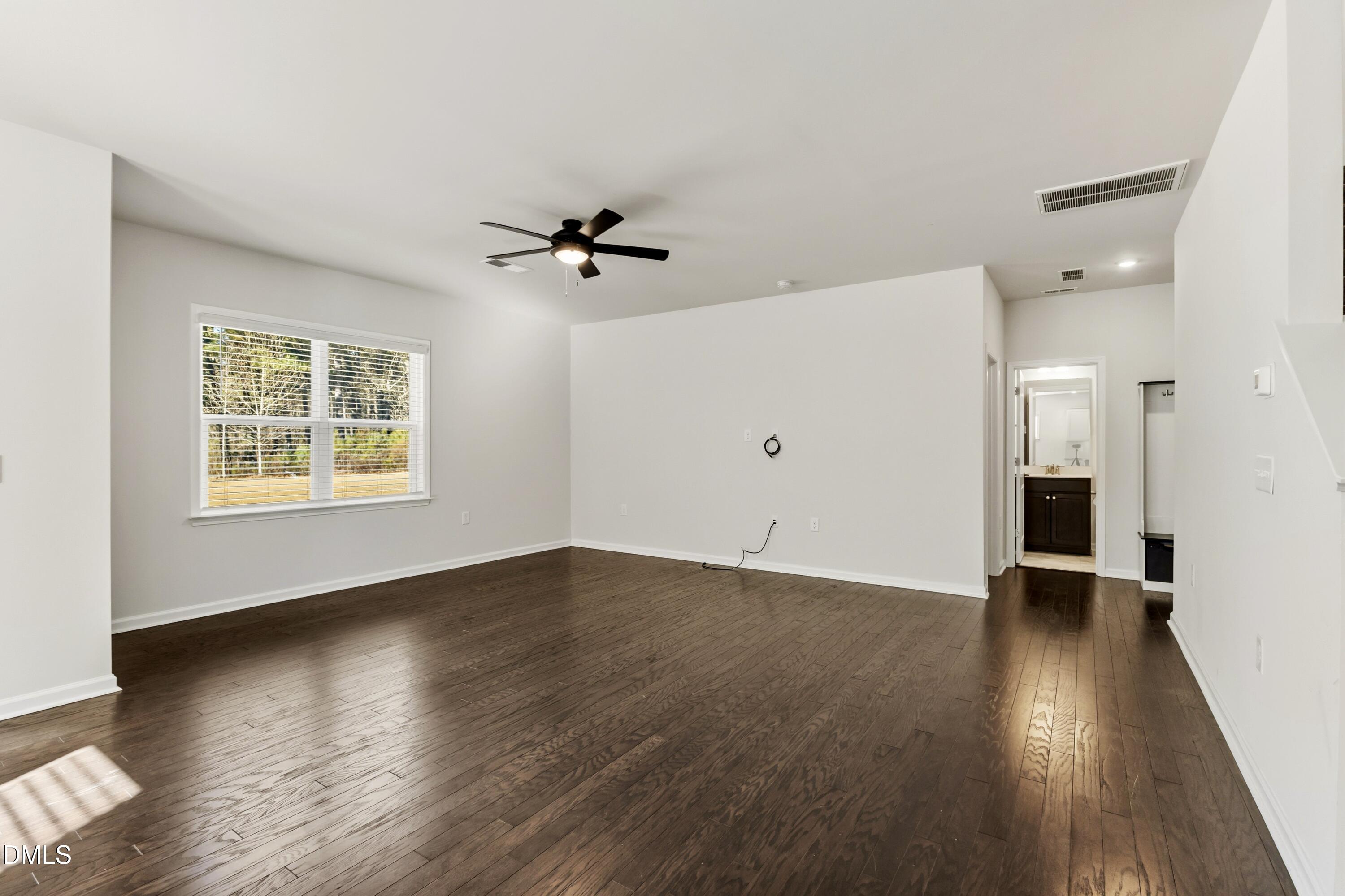1018 Flyfish Avenue Durham, NC 27703 - Photo 25 of 54 an empty room with wooden floor and windows