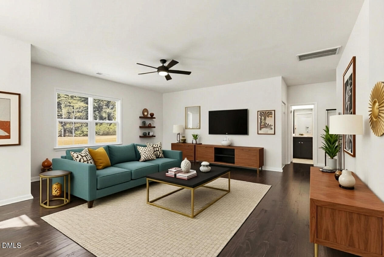 1018 Flyfish Avenue Durham, NC 27703 - Photo 26 of 54 a living room with furniture a flat screen tv and a window