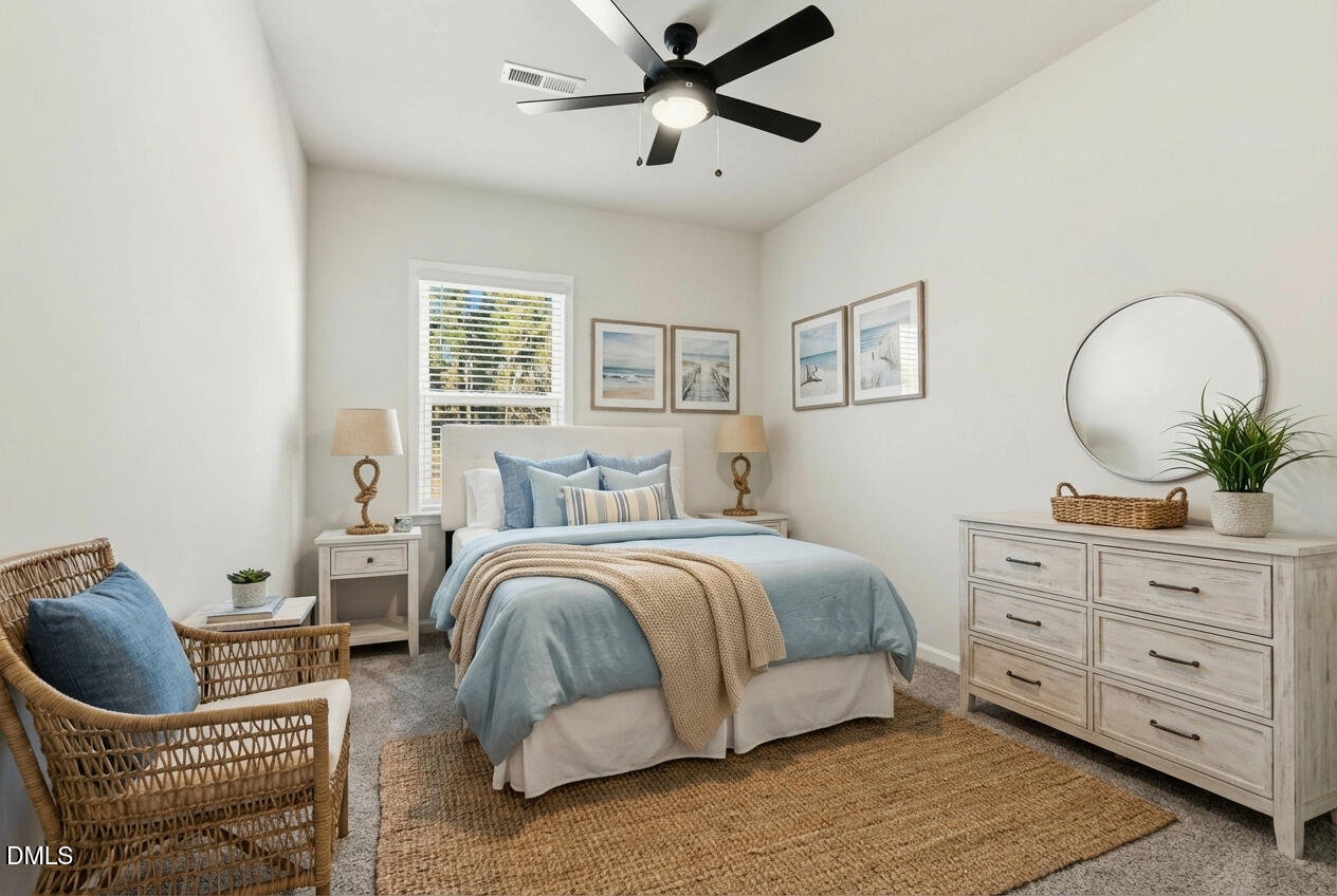 1018 Flyfish Avenue Durham, NC 27703 - Photo 29 of 54 a bedroom with a bed and ceiling fan