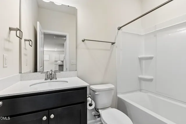 a view of a small space with wooden floor and a window
