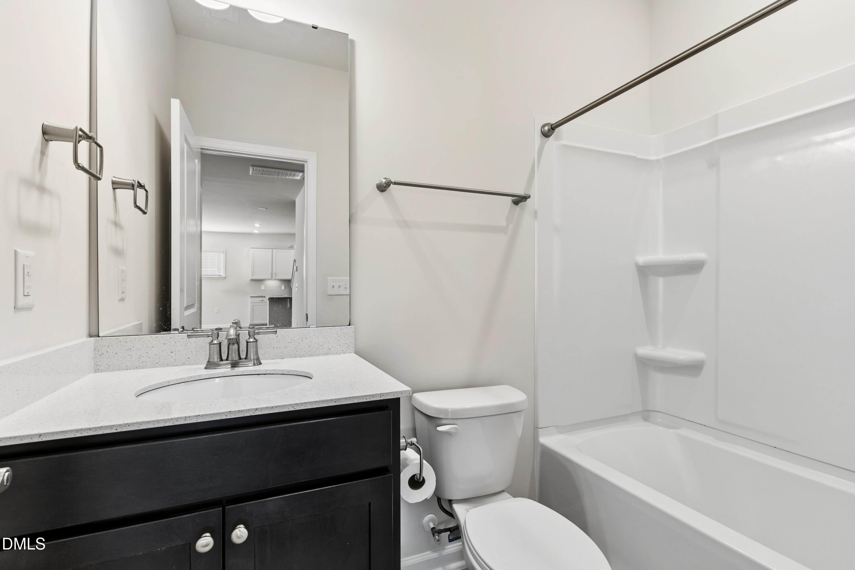 1018 Flyfish Avenue Durham, NC 27703 - Photo 31 of 54 a bathroom with a sink toilet and shower