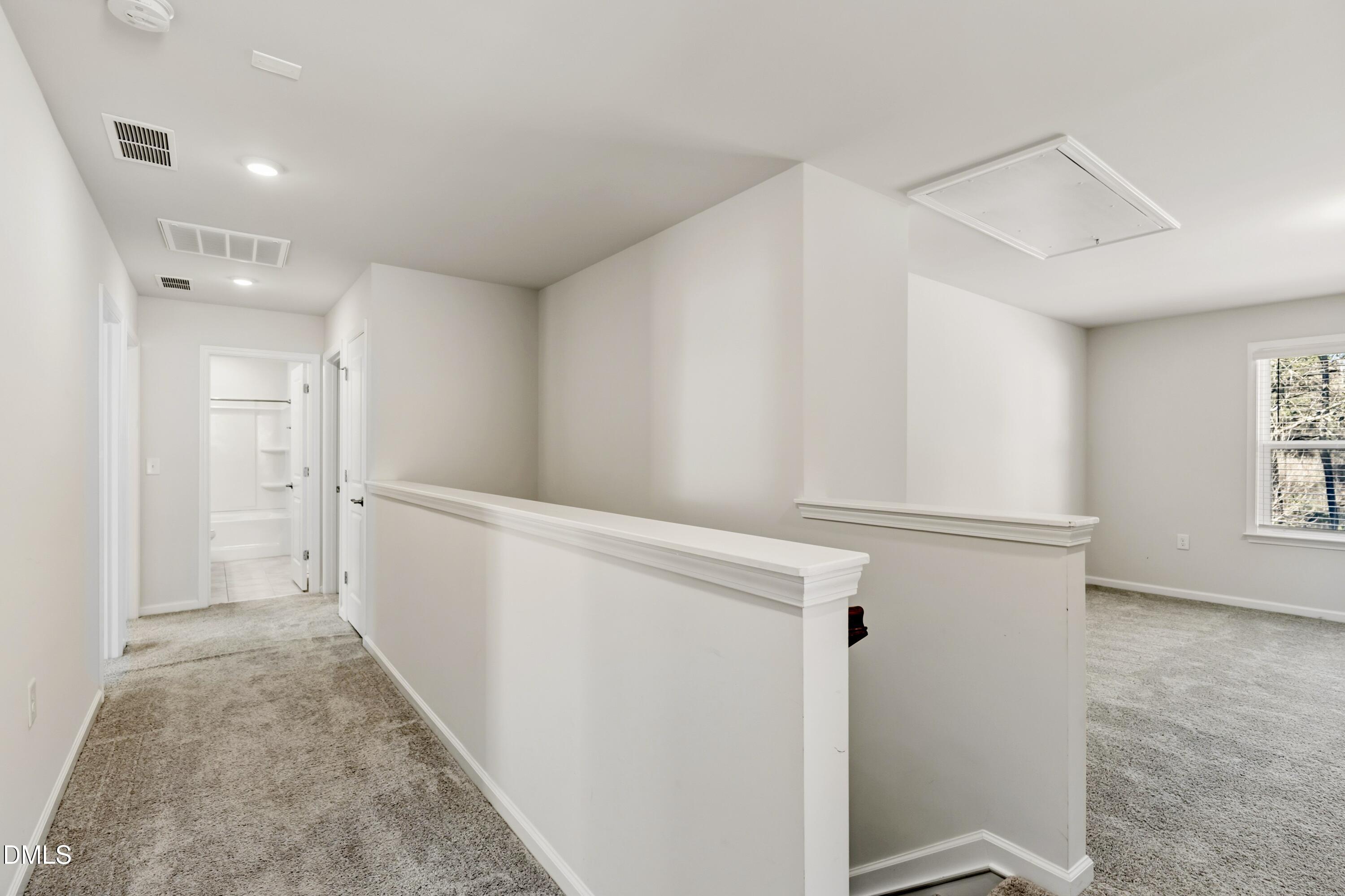 1018 Flyfish Avenue Durham, NC 27703 - Photo 32 of 54 a view of a hallway with white cabinets