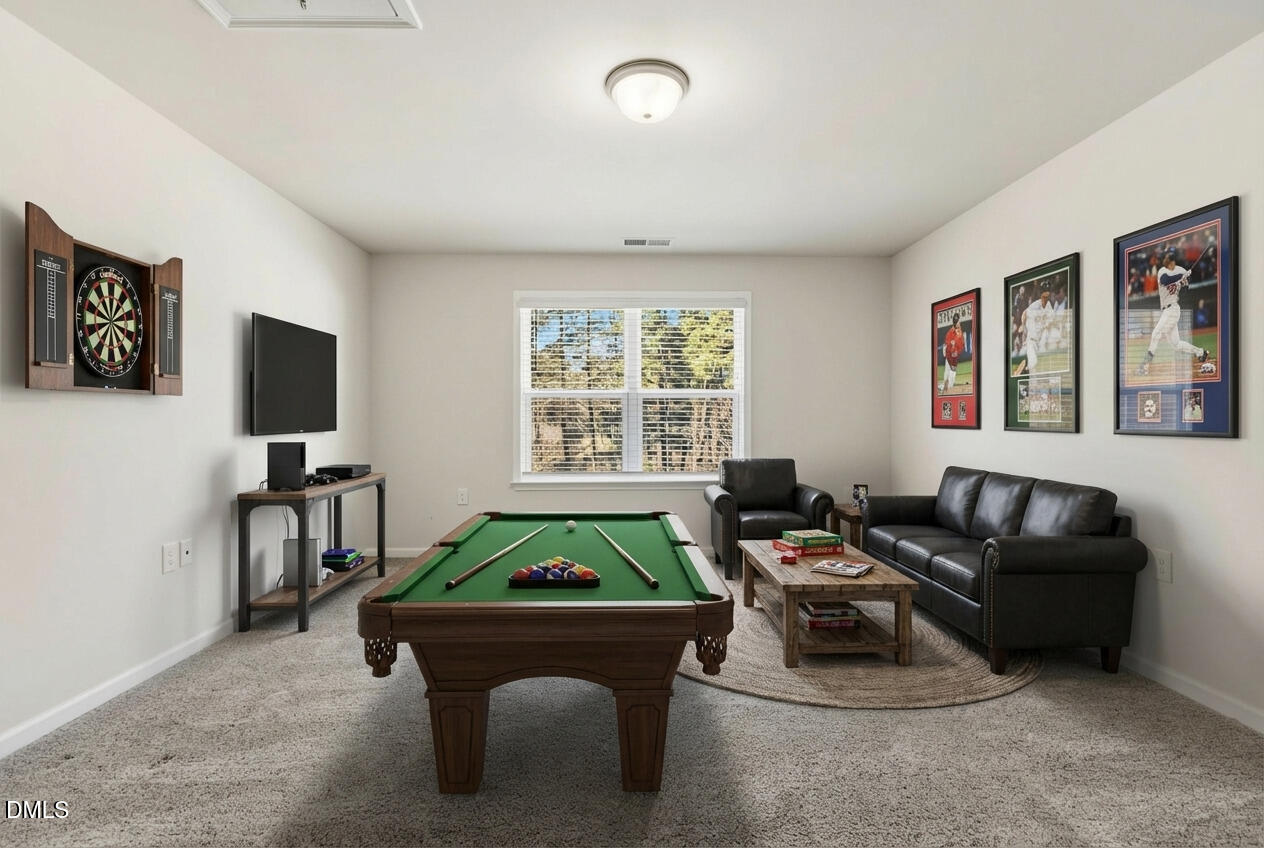 1018 Flyfish Avenue Durham, NC 27703 - Photo 34 of 54 a living room with furniture and a flat screen tv