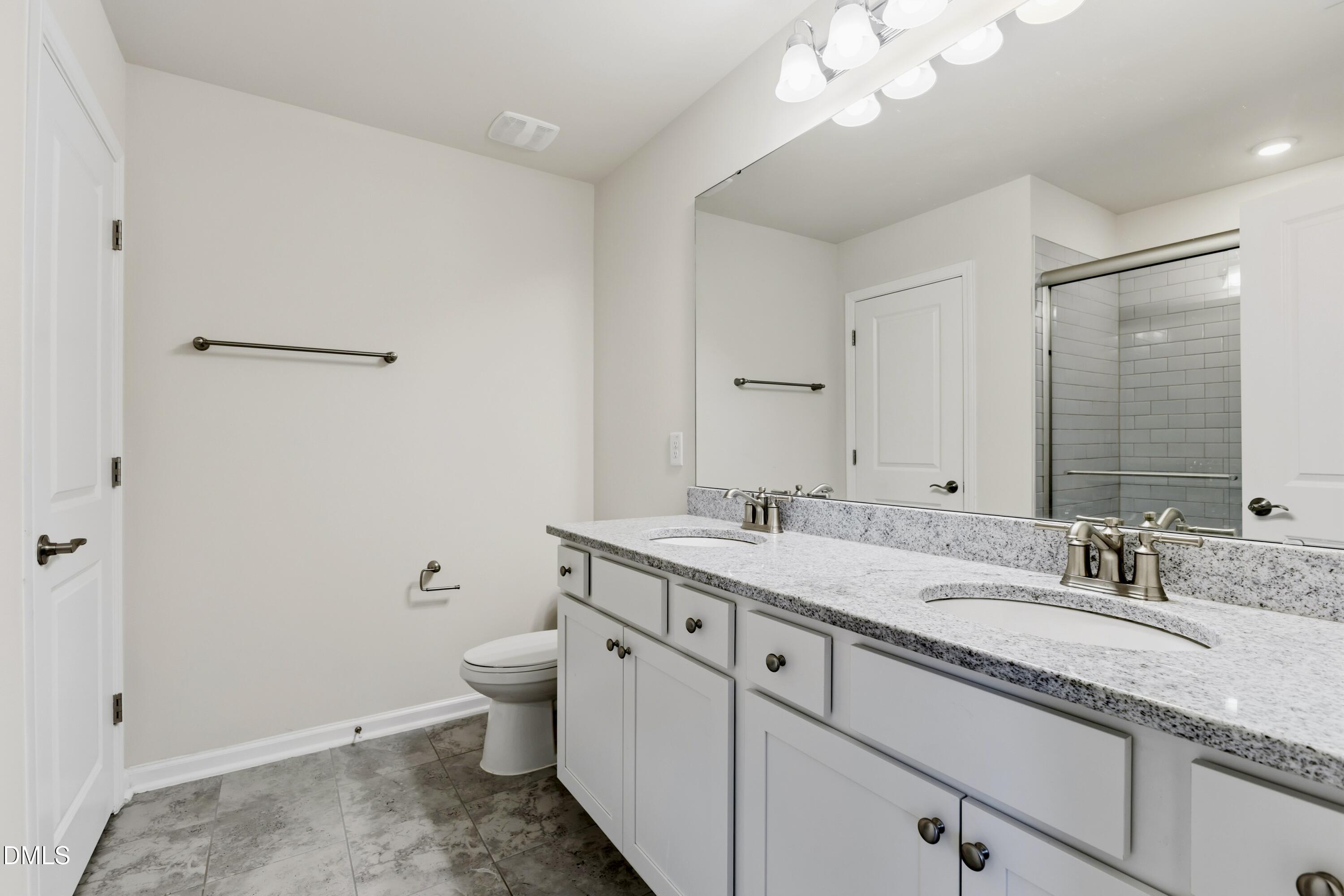 1018 Flyfish Avenue Durham, NC 27703 - Photo 39 of 54 a bathroom with a granite countertop sink a toilet and a mirror