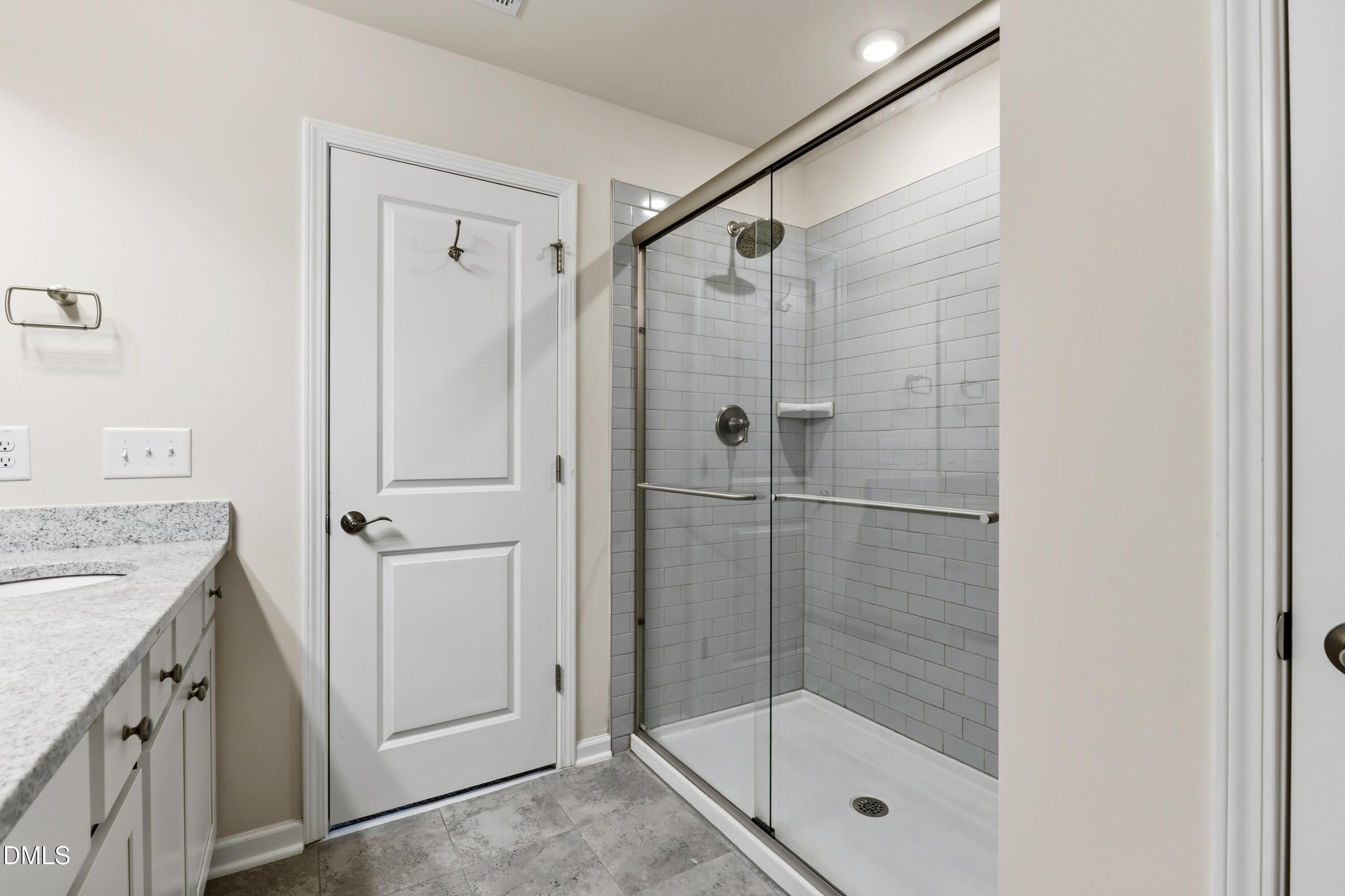 1018 Flyfish Avenue Durham, NC 27703 - Photo 40 of 54 a bathroom with a shower and a sink
