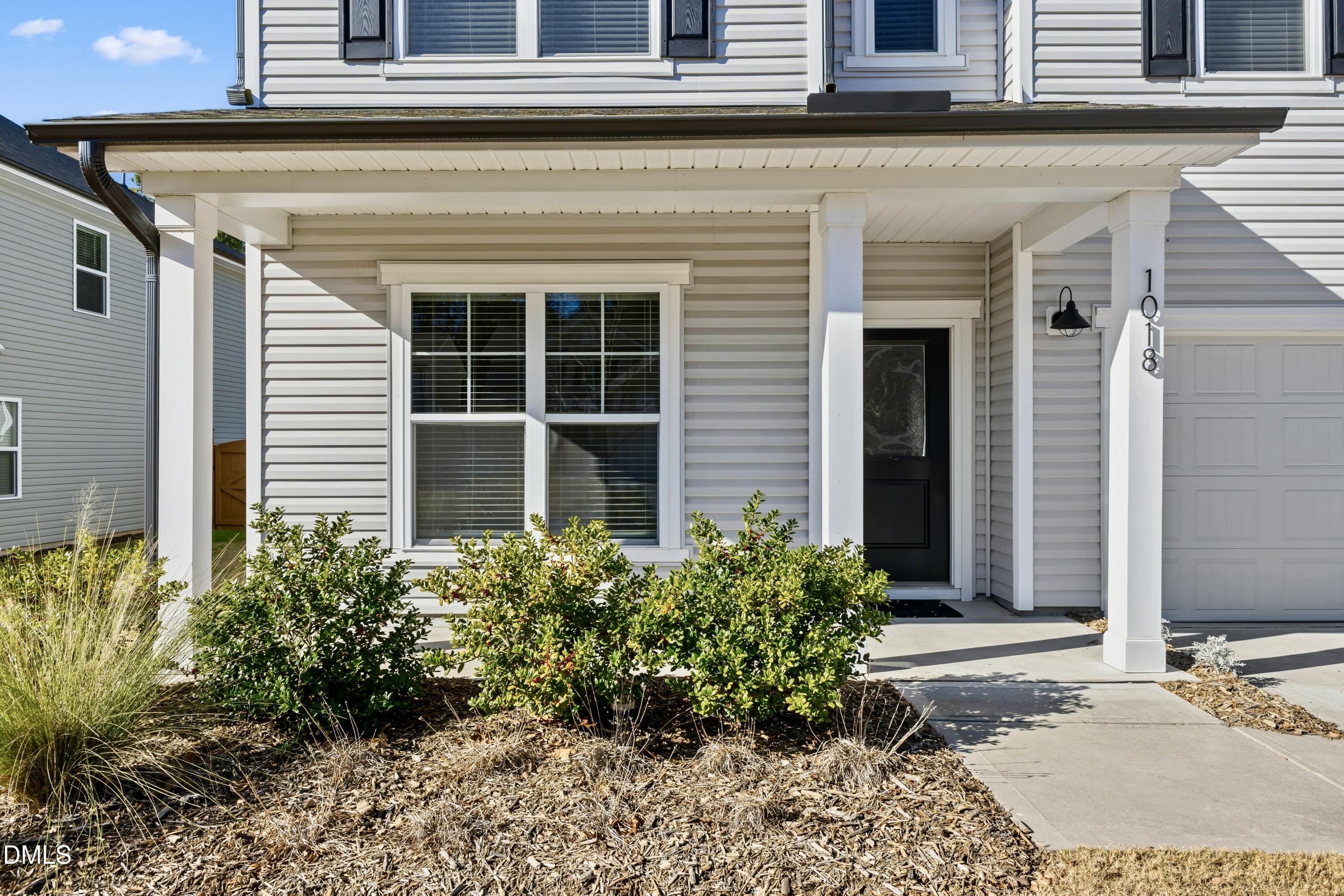 1018 Flyfish Avenue Durham, NC 27703 - Photo 8 of 54 a front view of a house with garden
