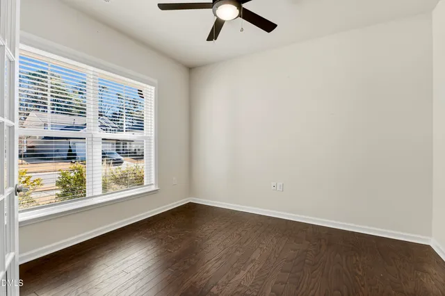 a kitchen with stainless steel appliances granite countertop a stove top oven a refrigerator a sink and dishwasher with wooden floor