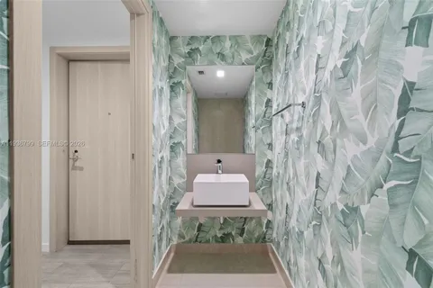 a bathroom with a sink and mirror