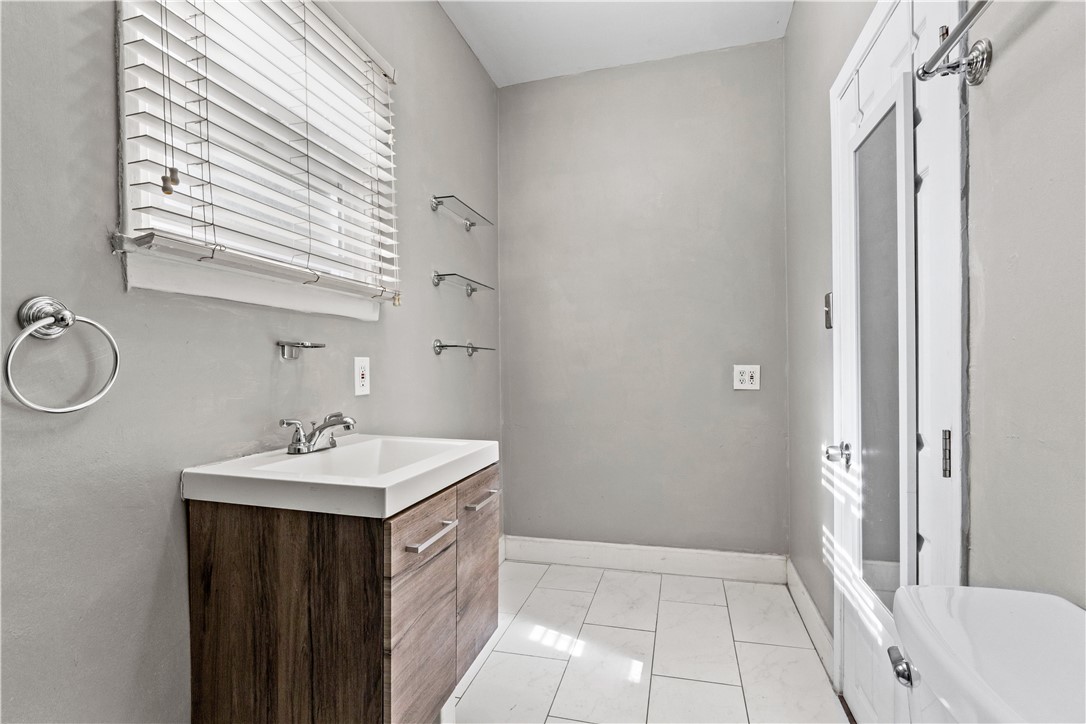 4073 Cedar Street Riverside, CA 92501 - Photo 18 of 46 a bathroom with a sink a mirror and a shower