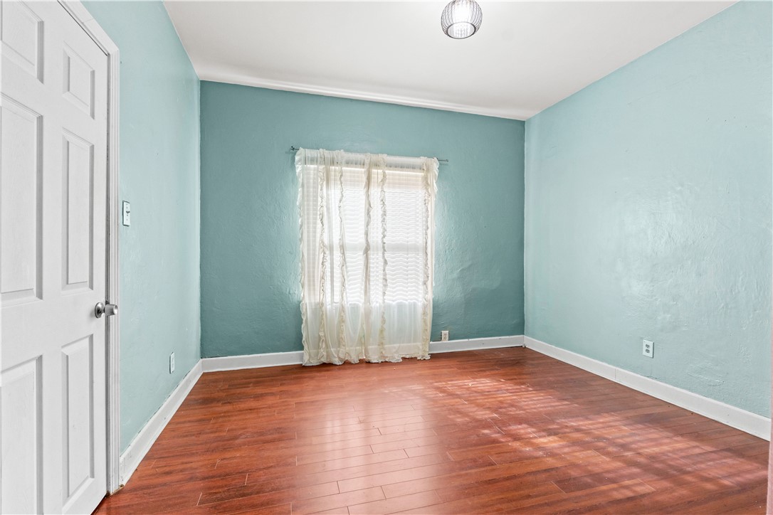 4073 Cedar Street Riverside, CA 92501 - Photo 19 of 46 an empty room with wooden floor and windows