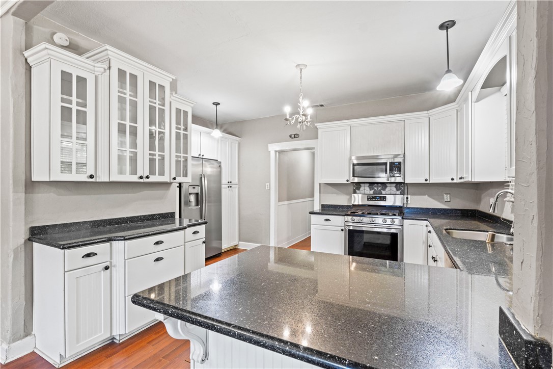 4073 Cedar Street Riverside, CA 92501 - Photo 21 of 46 a kitchen with stainless steel appliances a stove sink microwave and cabinets