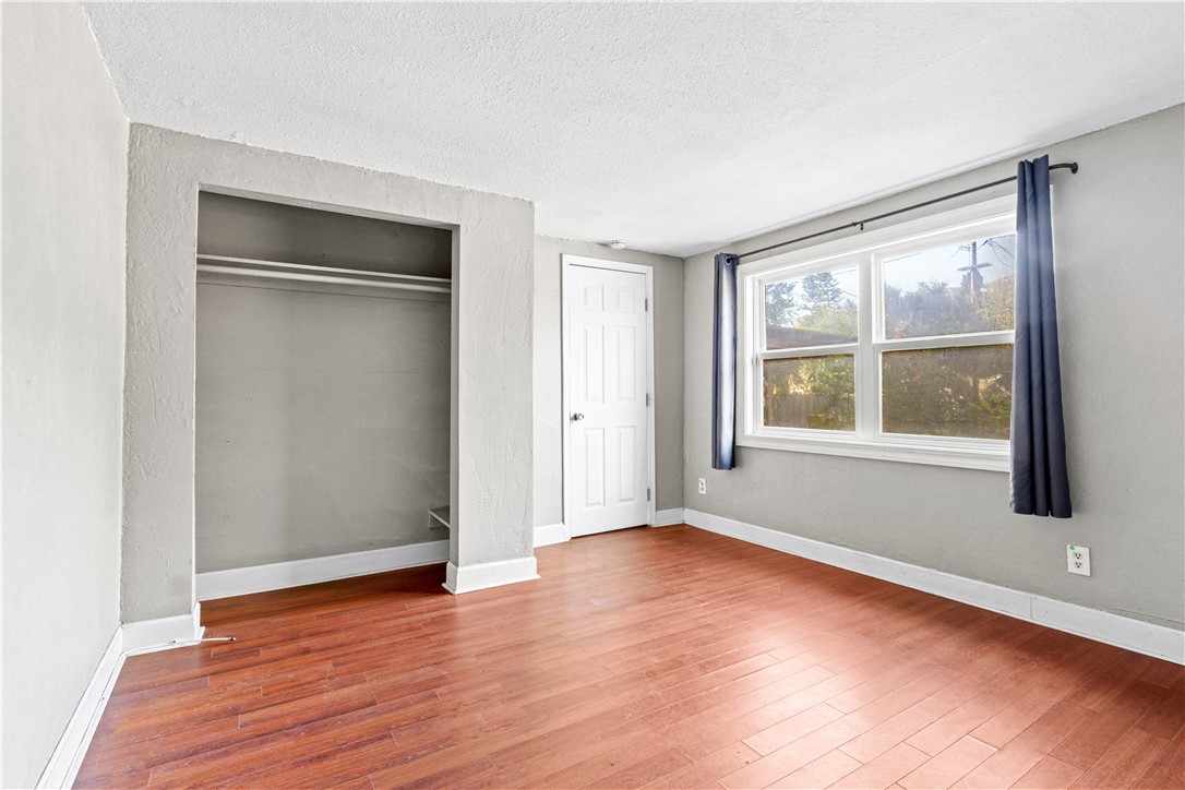 4073 Cedar Street Riverside, CA 92501 - Photo 28 of 46 an empty room with wooden floor and windows