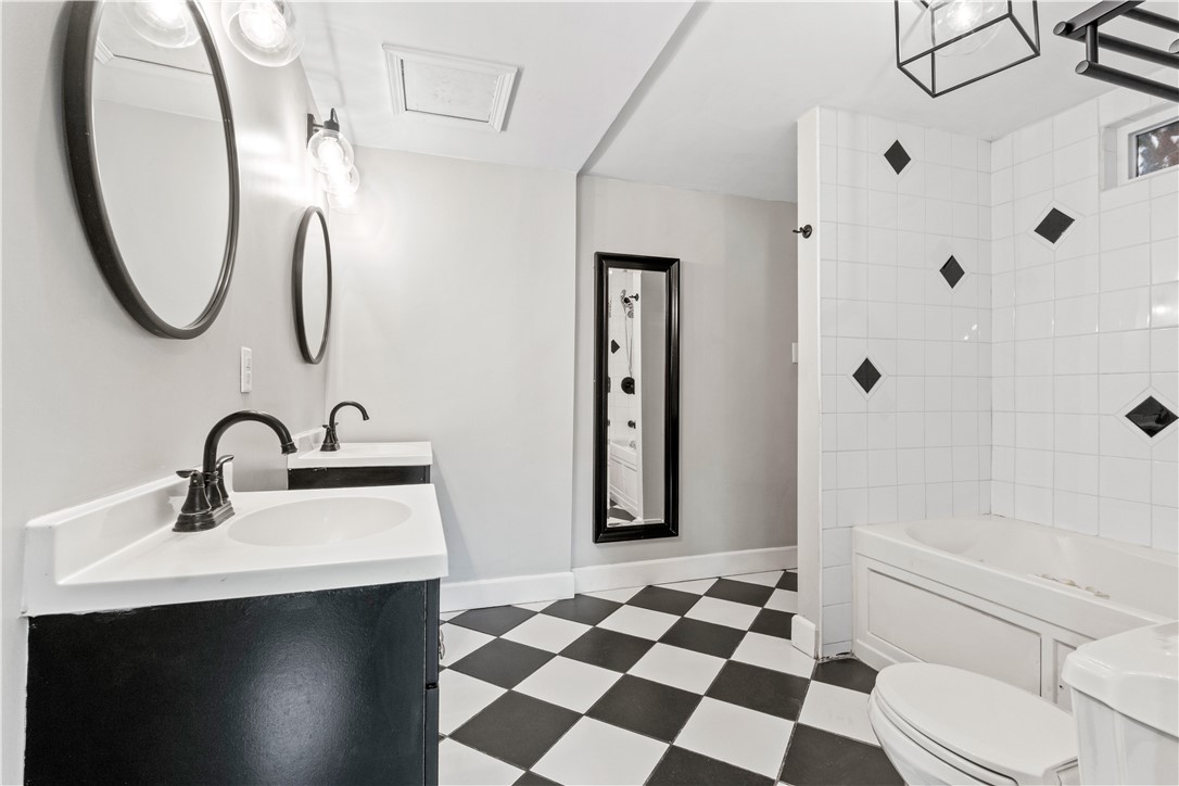 4073 Cedar Street Riverside, CA 92501 - Photo 33 of 46 a bathroom with a sink a toilet and a mirror
